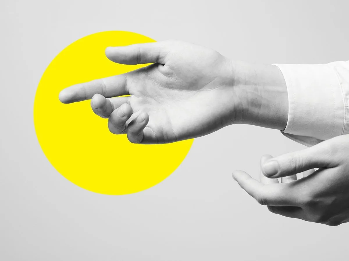 Two hands gesturing in conversation against a yellow circle